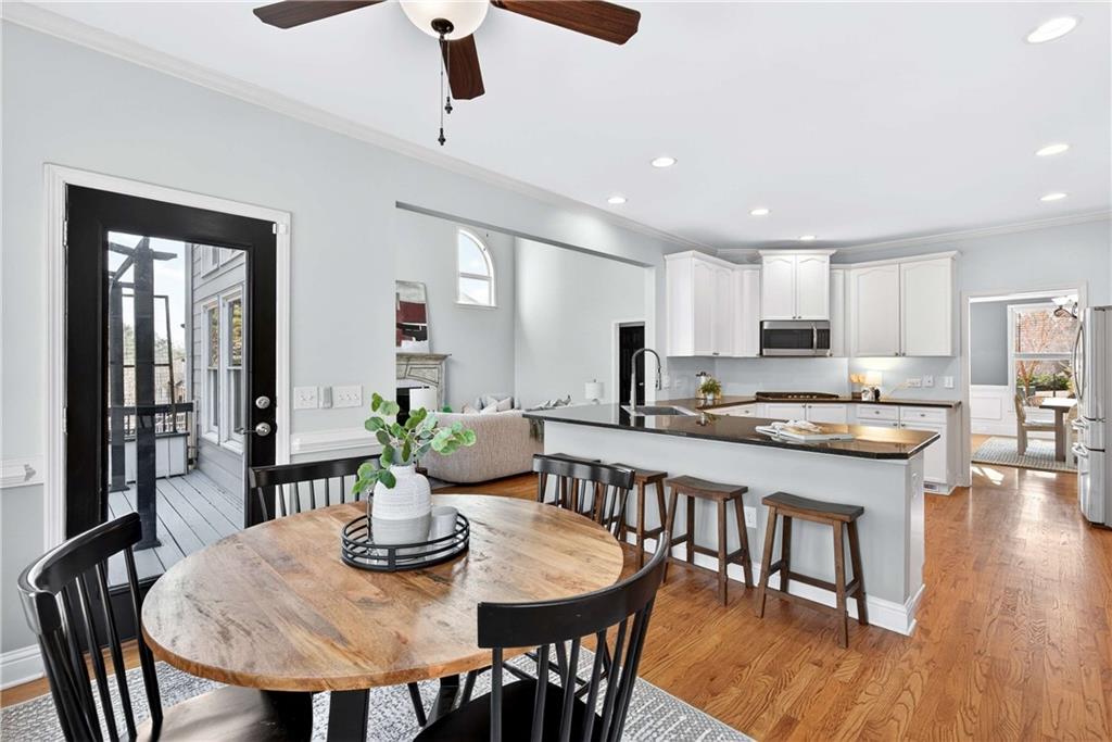 167 Calming Water Trail Dallas, GA 30132 - Photo 17 of 64 a kitchen with stainless steel appliances granite countertop a dining table chairs and white cabinets