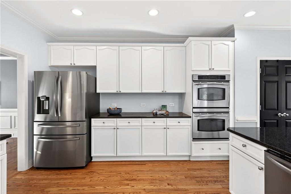167 Calming Water Trail Dallas, GA 30132 - Photo 20 of 64 a kitchen with granite countertop a refrigerator stove and microwave