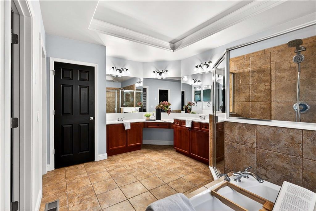167 Calming Water Trail Dallas, GA 30132 - Photo 26 of 64 a large bathroom with a tub sink and mirror