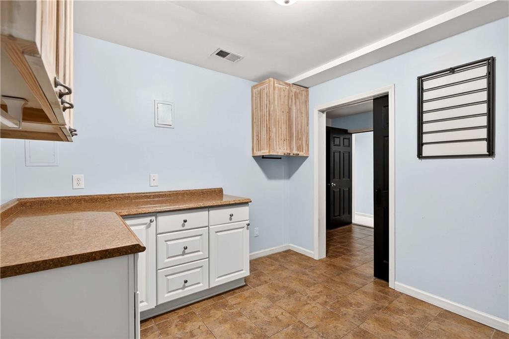 167 Calming Water Trail Dallas, GA 30132 - Photo 39 of 64 a kitchen with white cabinets and white appliances