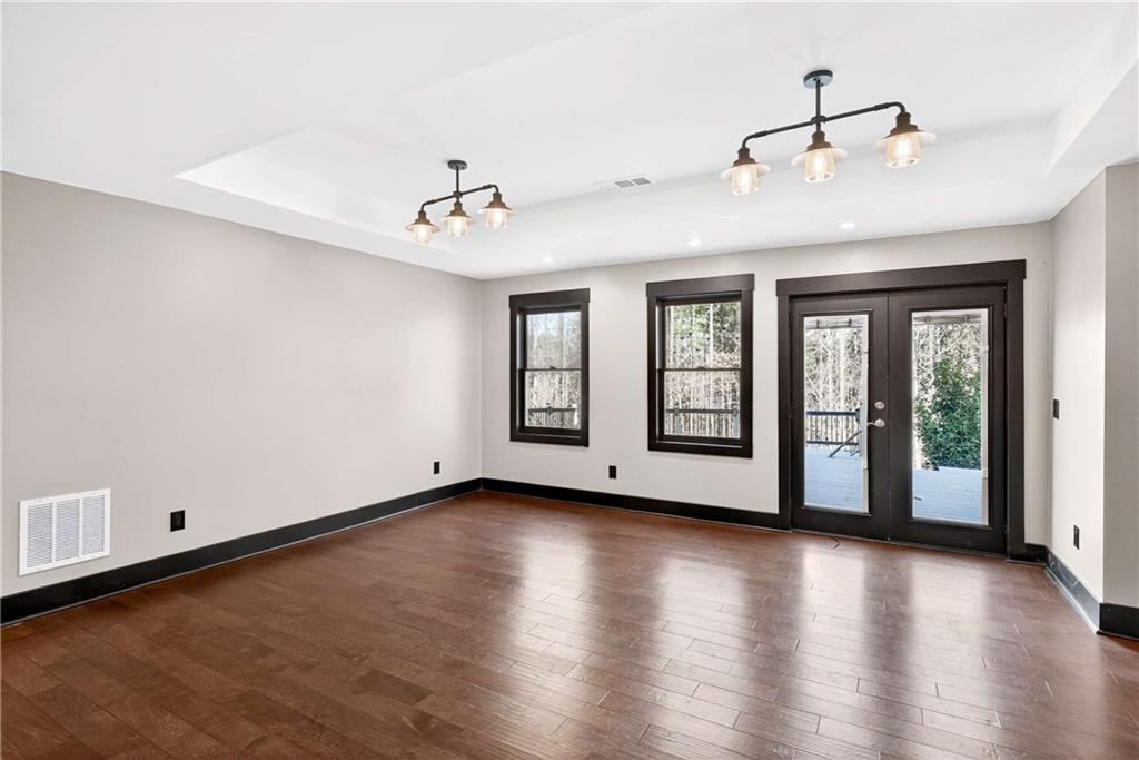 167 Calming Water Trail Dallas, GA 30132 - Photo 45 of 64 a view of an empty room with wooden floor and a window