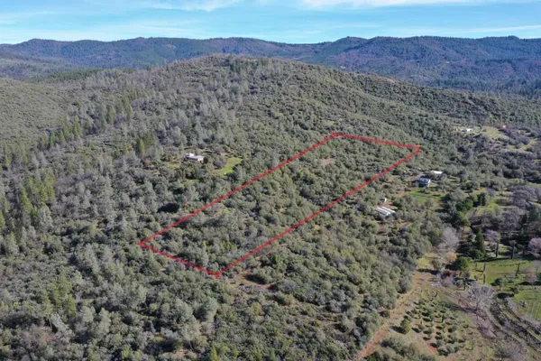 a view of a lush green hillside and a building