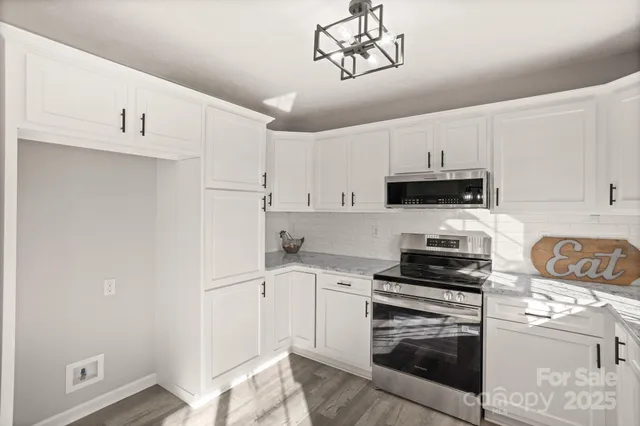 a kitchen with cabinets appliances and a sink