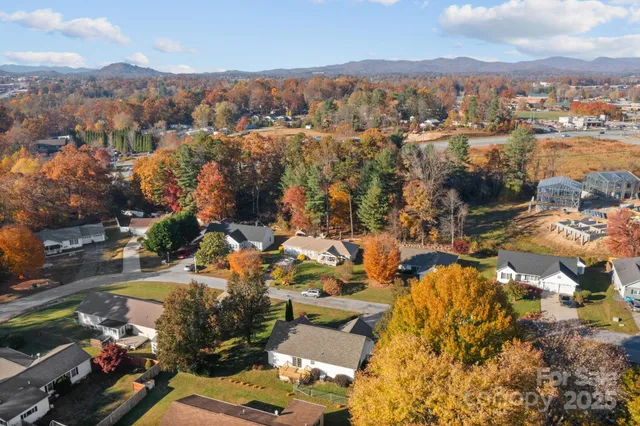an aerial view of residential house with green space