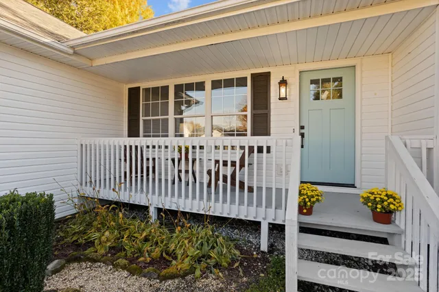 a view of a chair and table in front of house