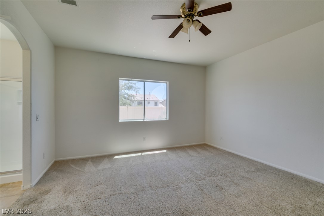 5150 Riverside Run Court North Las Vegas, NV 89081 - Photo 38 of 50 A spacious bedroom featuring soft carpeting and a ceiling fan, offering a comfortable retreat.