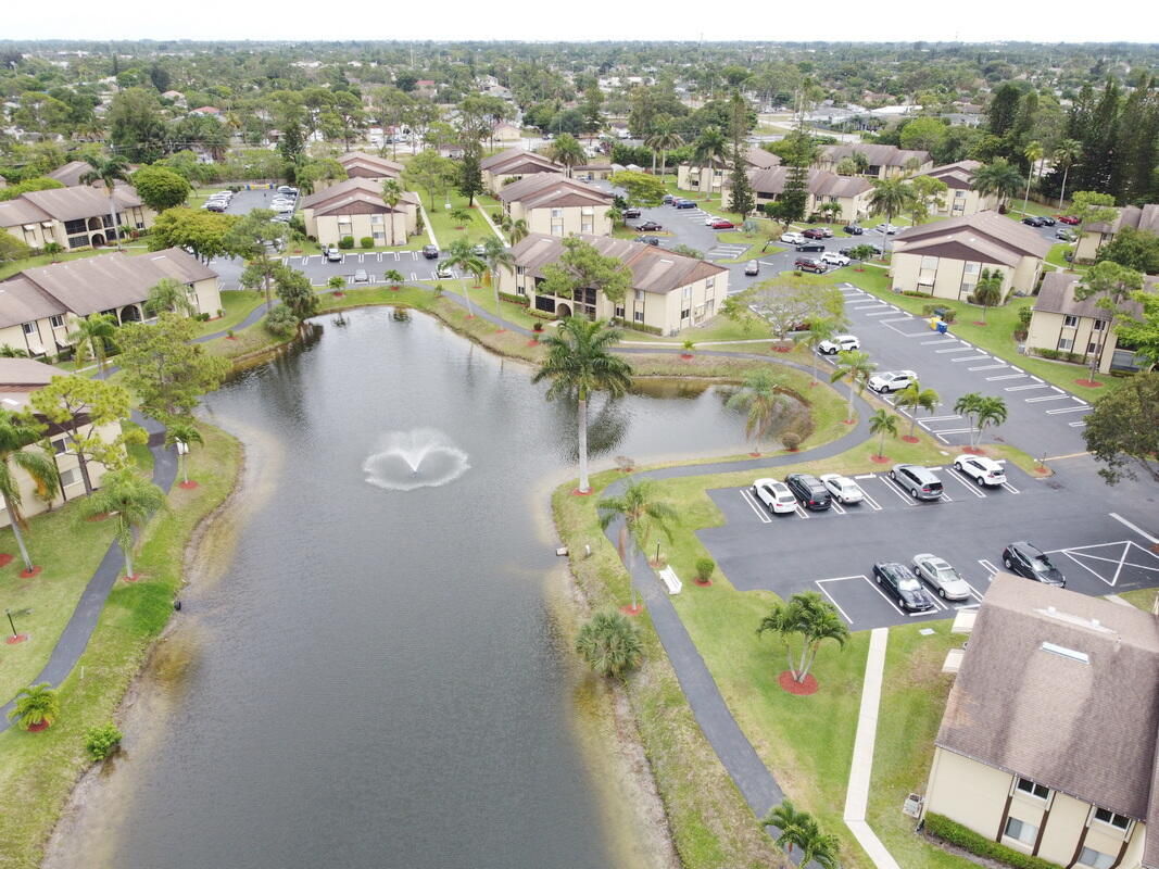 320 Pine Ridge Circle, Unit A1 Greenacres, FL 33463 - Photo 61 of 65 an aerial view of a house with a swimming pool