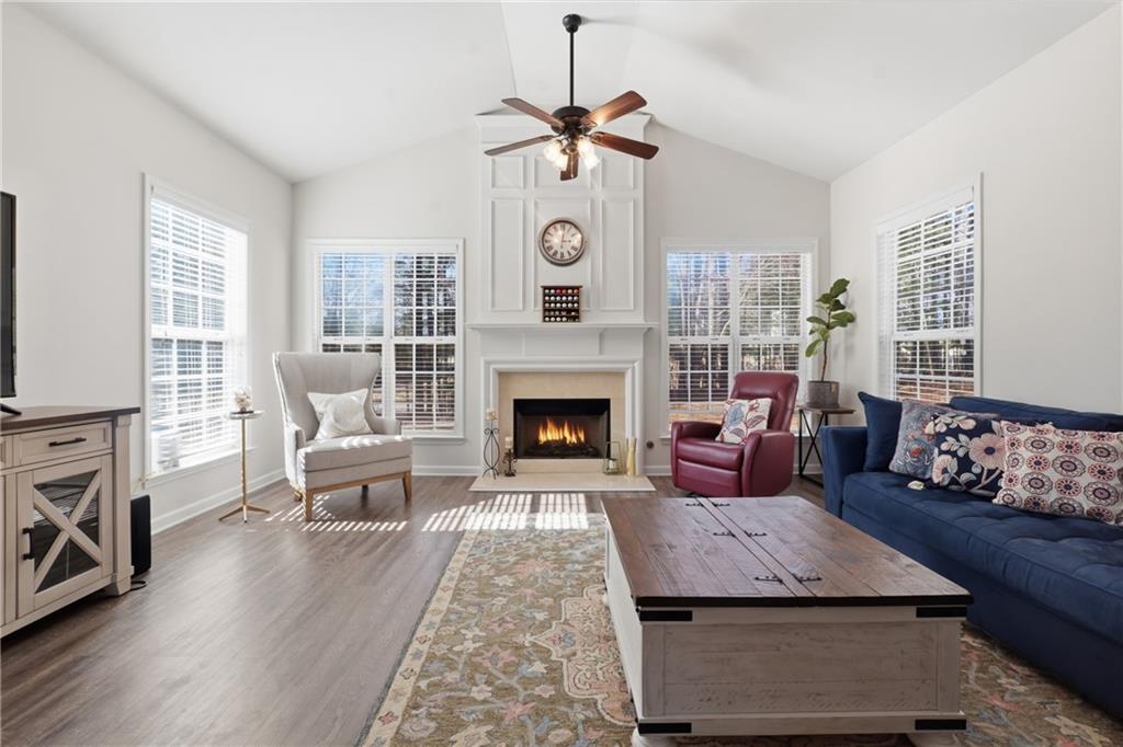 38 Crystal Downs Way Northeast Suwanee, GA 30024 - Photo 16 of 44 a living room with furniture a fireplace and window
