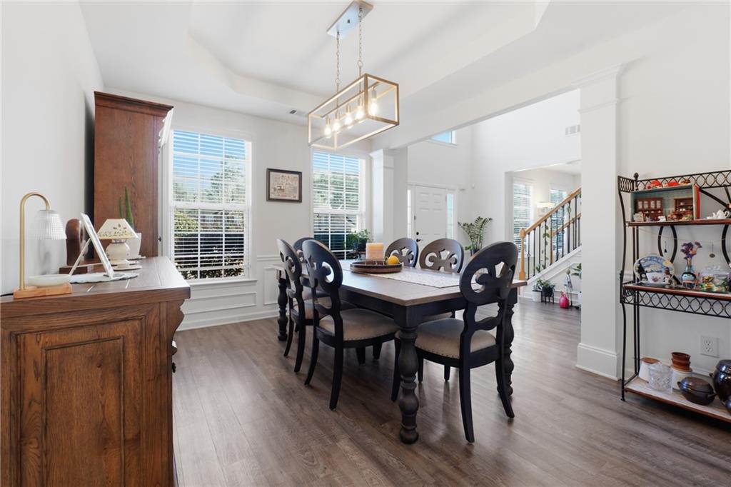 38 Crystal Downs Way Northeast Suwanee, GA 30024 - Photo 19 of 44 a view of a a dining room with furniture window and wooden floor