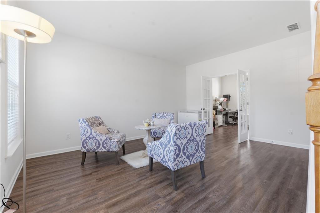 38 Crystal Downs Way Northeast Suwanee, GA 30024 - Photo 20 of 44 a living room with furniture and wooden floor