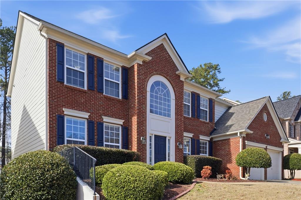 38 Crystal Downs Way Northeast Suwanee, GA 30024 - Photo 2 of 44 a front view of a house with a yard