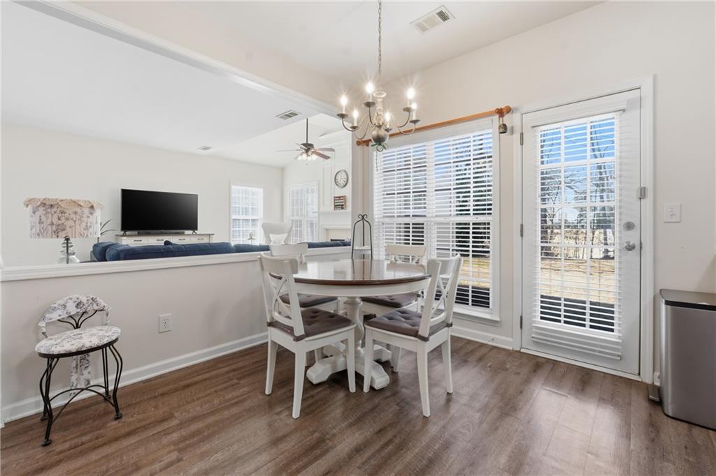 38 Crystal Downs Way Northeast Suwanee, GA 30024 - Photo 23 of 44 a view of a dining room with furniture window and wooden floor