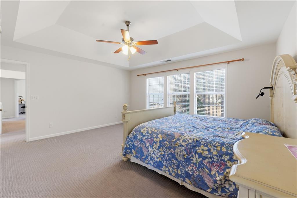 38 Crystal Downs Way Northeast Suwanee, GA 30024 - Photo 25 of 44 a bedroom with a bed and a window