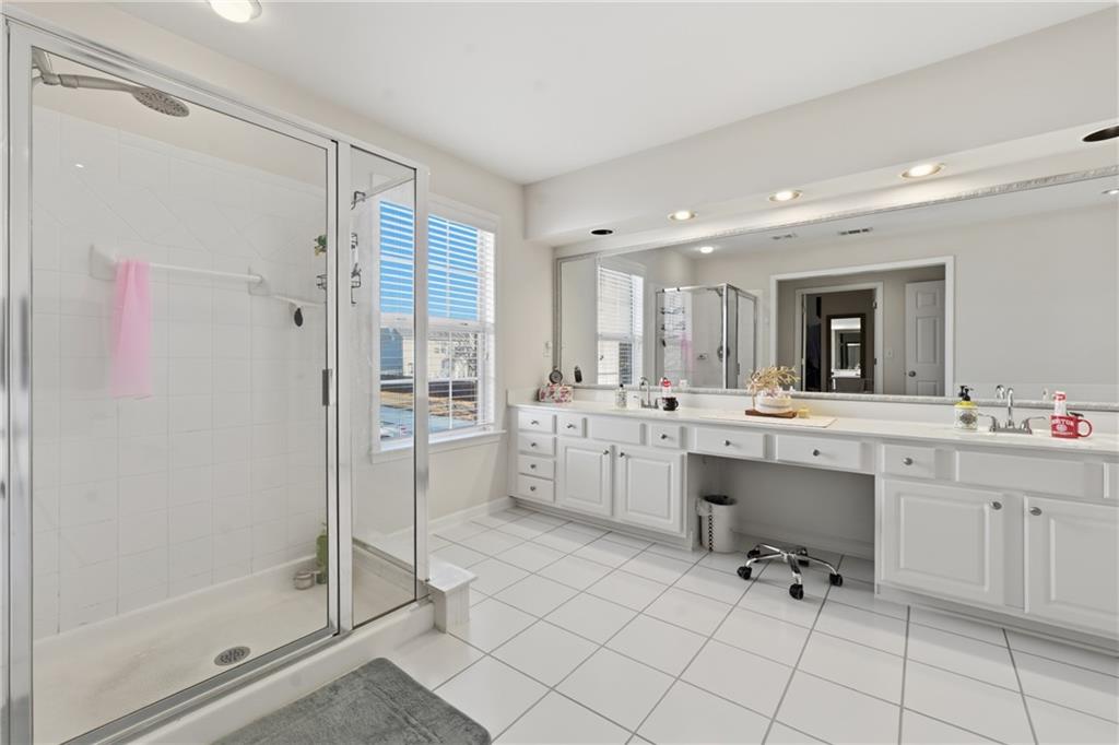 38 Crystal Downs Way Northeast Suwanee, GA 30024 - Photo 28 of 44 a large white bathroom with a double vanity sink mirror and shower