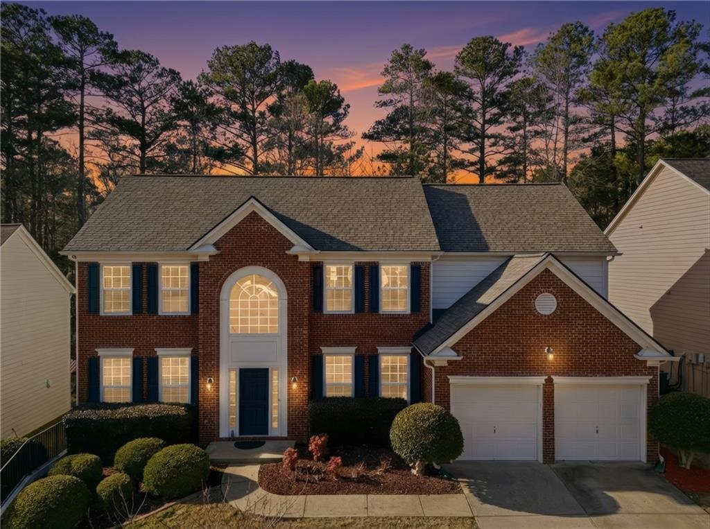 38 Crystal Downs Way Northeast Suwanee, GA 30024 - Photo 3 of 44 a front view of a house with a yard