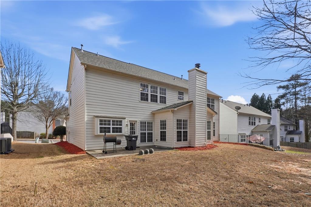 38 Crystal Downs Way Northeast Suwanee, GA 30024 - Photo 39 of 44 a view of a house with a patio