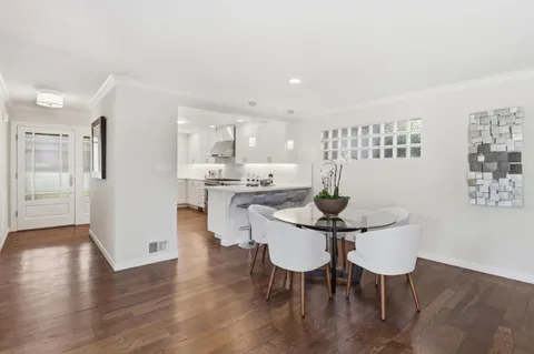 a dining room with furniture and wooden floor