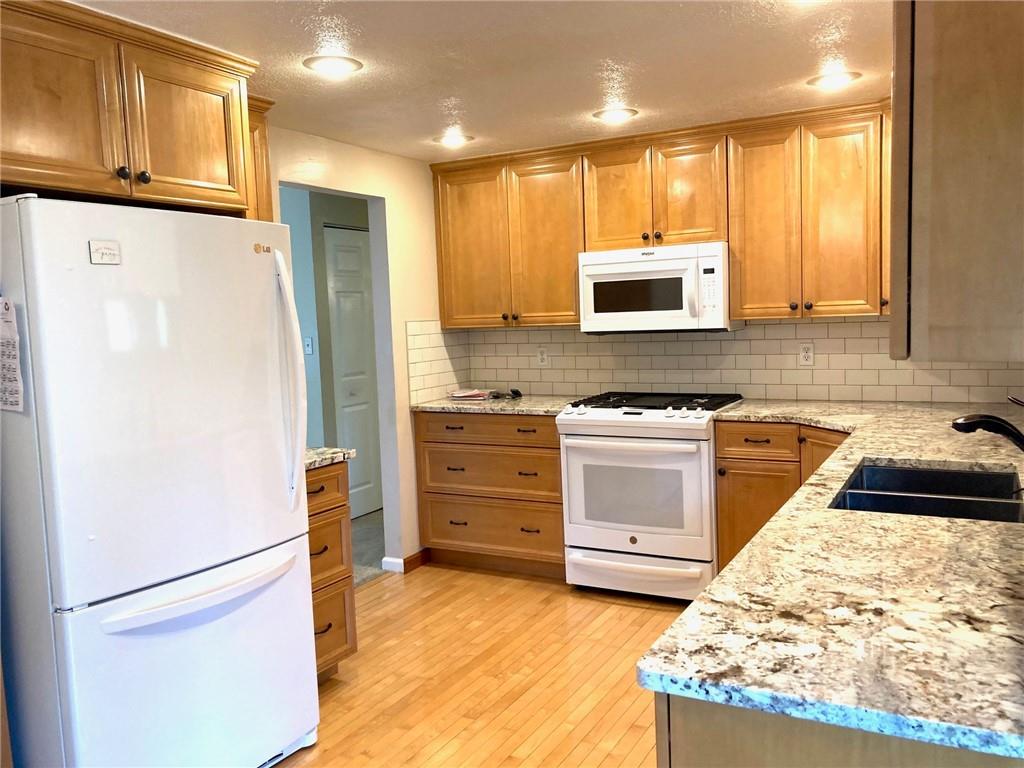 3054 Pitchfork Drive McKees Rocks, PA 15136 - Photo 3 of 33 a kitchen with granite countertop a refrigerator stove and microwave