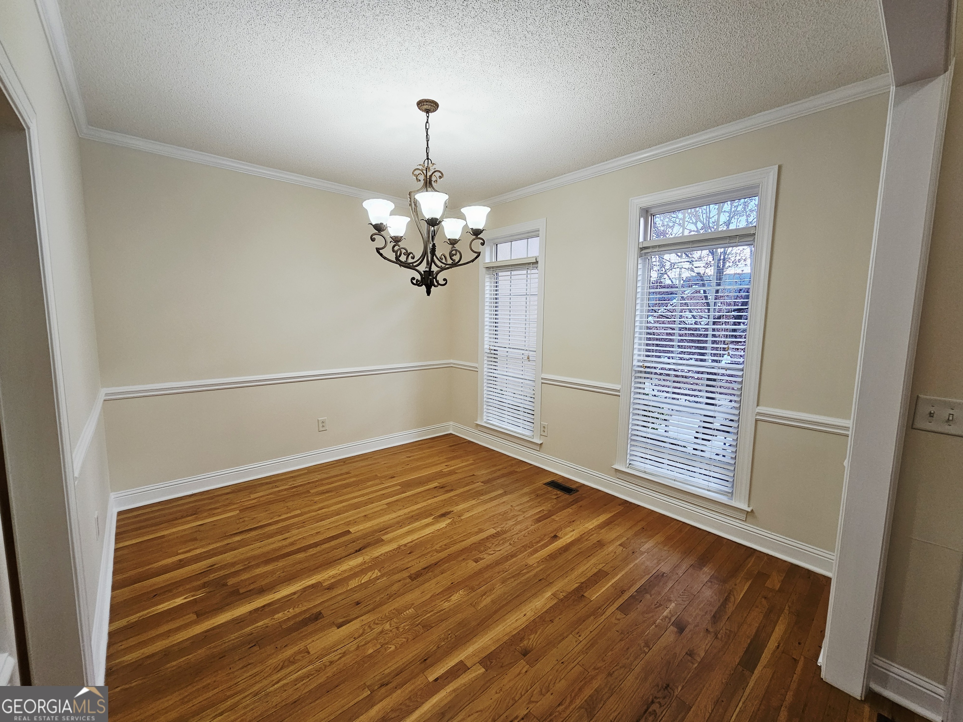 122 High Ridge Drive Macon, GA 31220 - Photo 5 of 25 a view of an empty room with wooden floor and a window