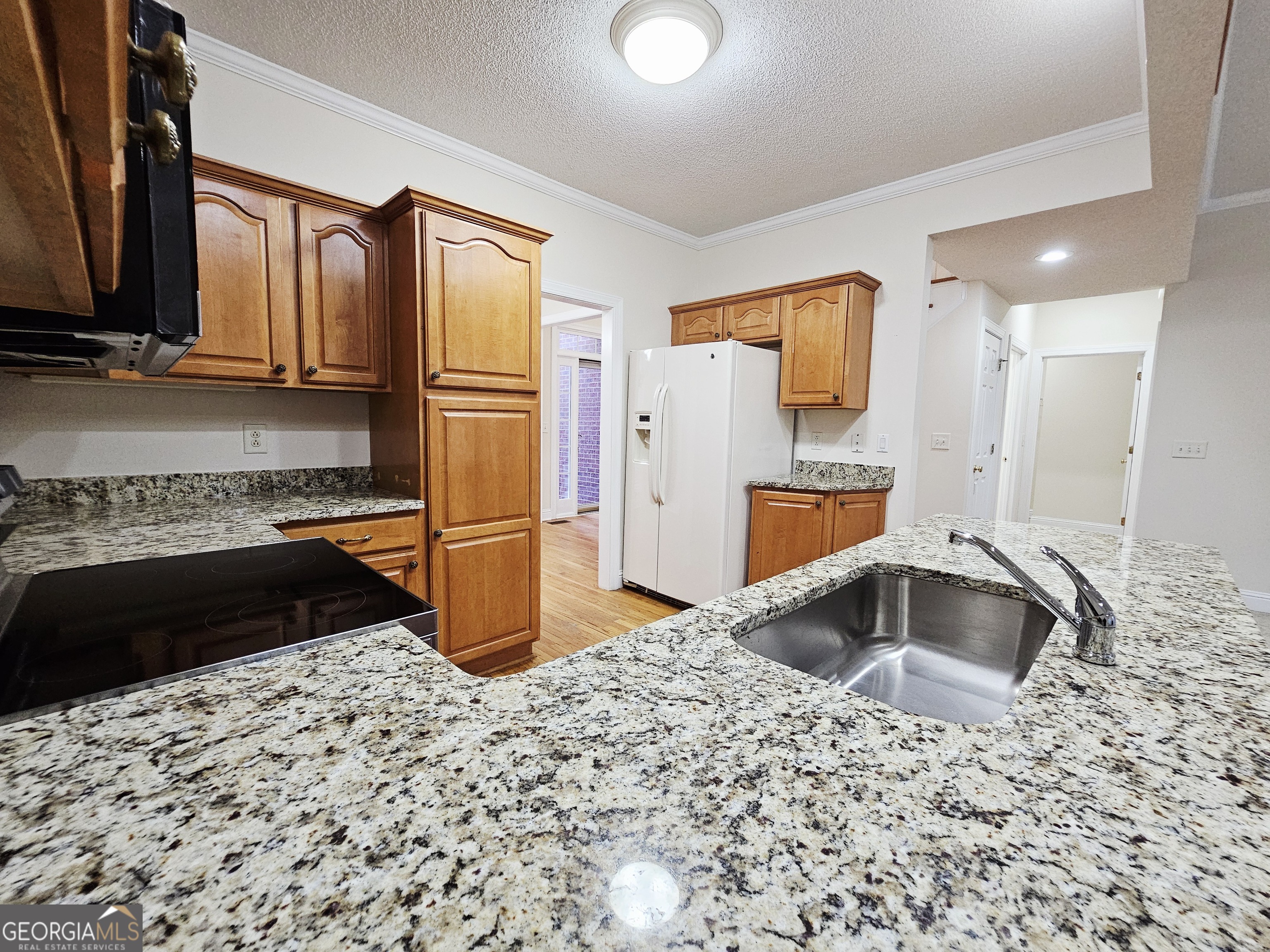 122 High Ridge Drive Macon, GA 31220 - Photo 8 of 25 a kitchen with granite countertop a refrigerator and a sink