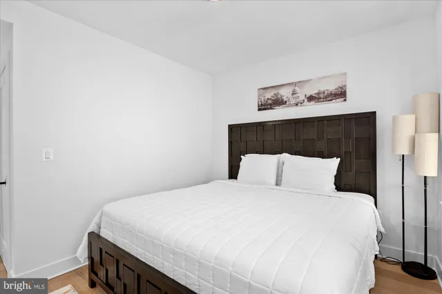 a large bed sitting in a bedroom and a table