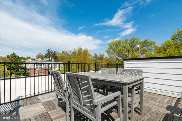 a view of a roof deck with furniture