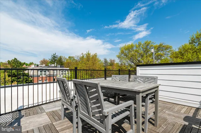 a view of a roof deck with furniture