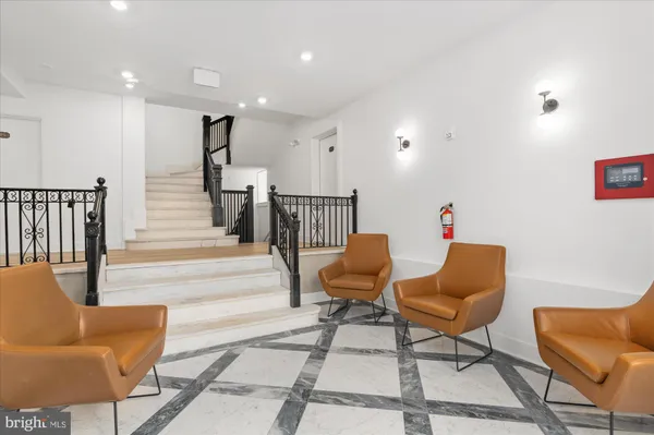 a living room with furniture and a dining table with wooden floor