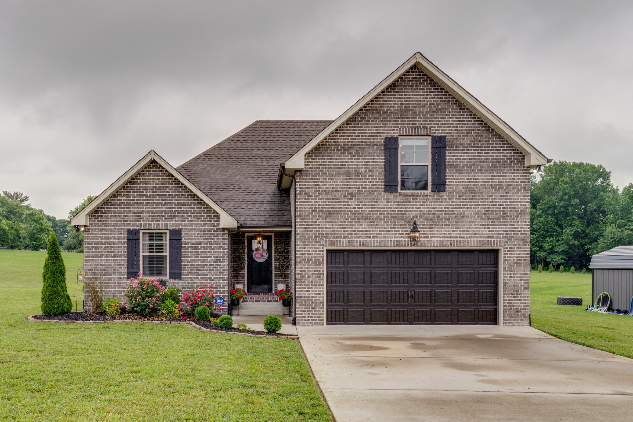 338 Tom Ferrell Road Portland, TN 37148 - Photo 2 of 26 a front view of a house with a garden and yard