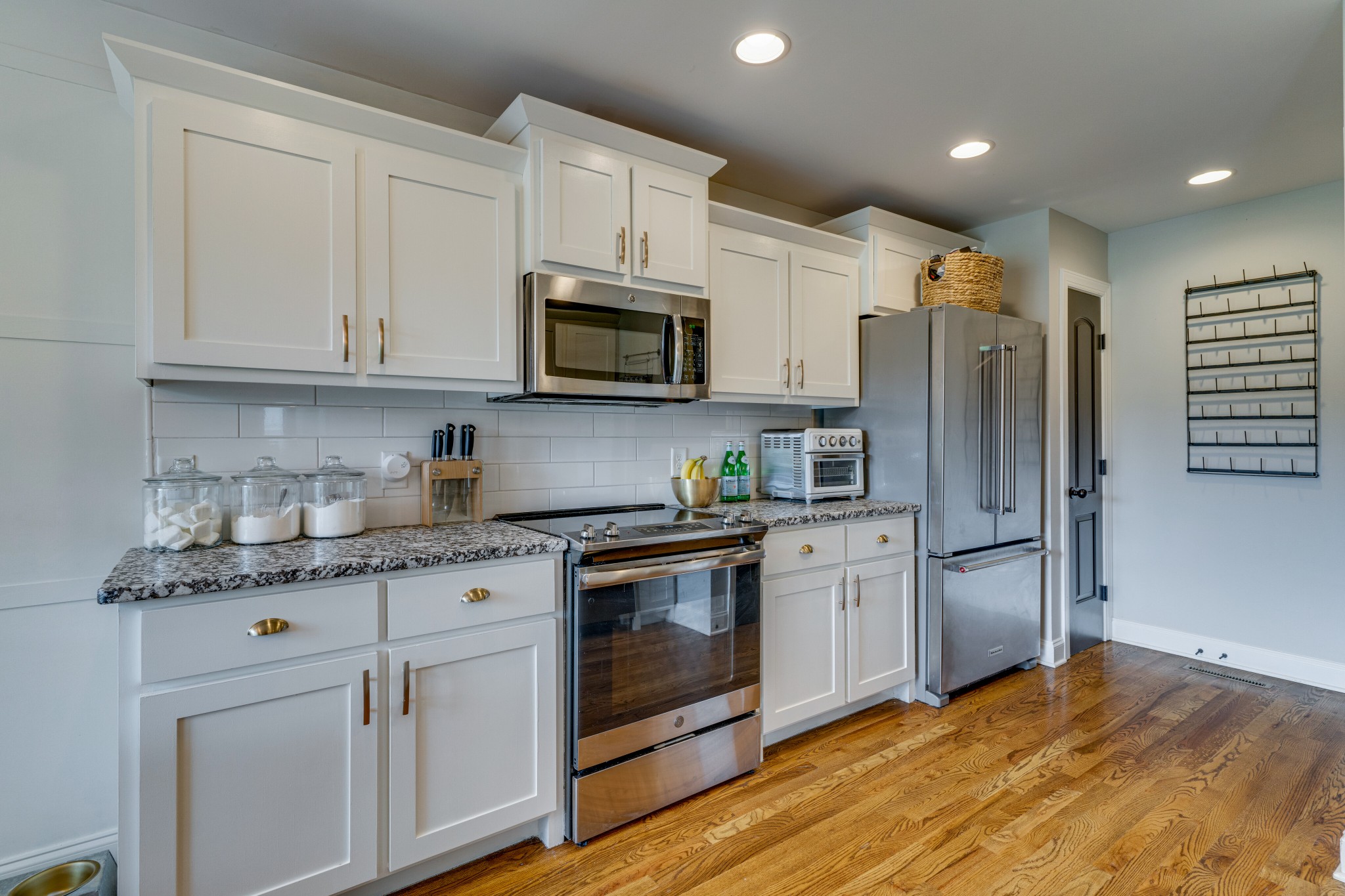 338 Tom Ferrell Road Portland, TN 37148 - Photo 12 of 26 a kitchen with granite countertop a refrigerator stove and microwave