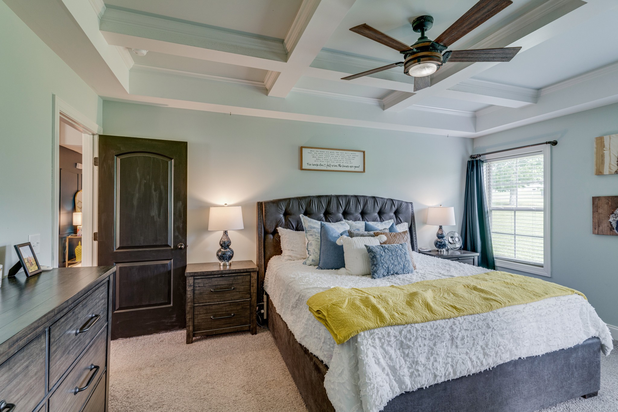 338 Tom Ferrell Road Portland, TN 37148 - Photo 13 of 26 a bedroom with a large bed and a chandelier