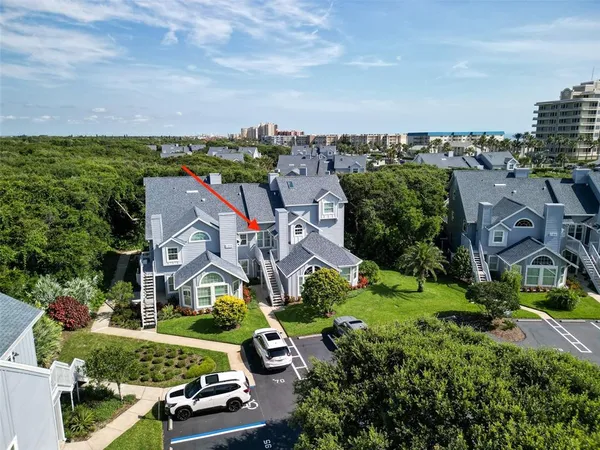 an aerial view of multiple houses with a yard