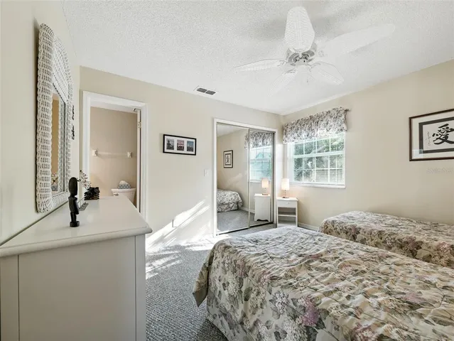 a bedroom with two beds and a window