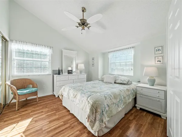 a spacious bedroom with a bed and a chandelier