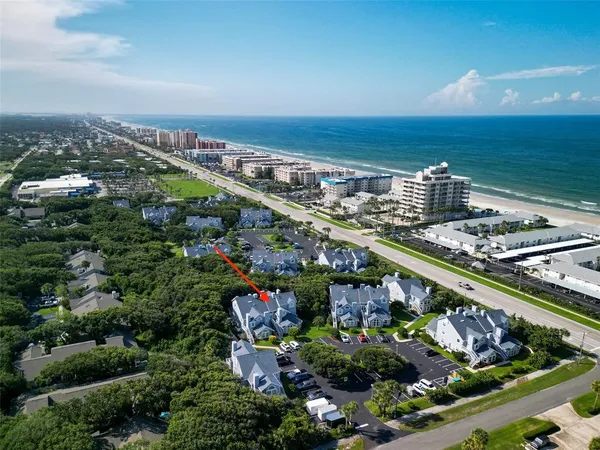 an aerial view of residential house with outdoor space and seating
