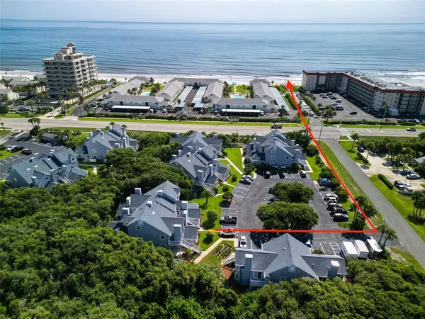 an aerial view of a house with a yard basket ball court and outdoor seating