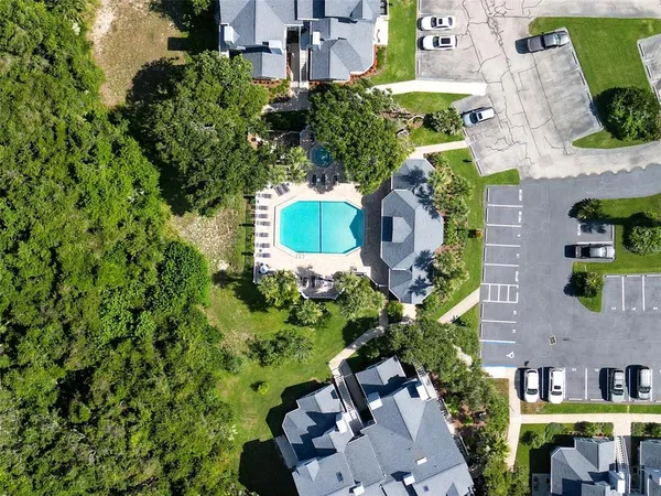 an aerial view of a house with yard swimming pool and outdoor seating