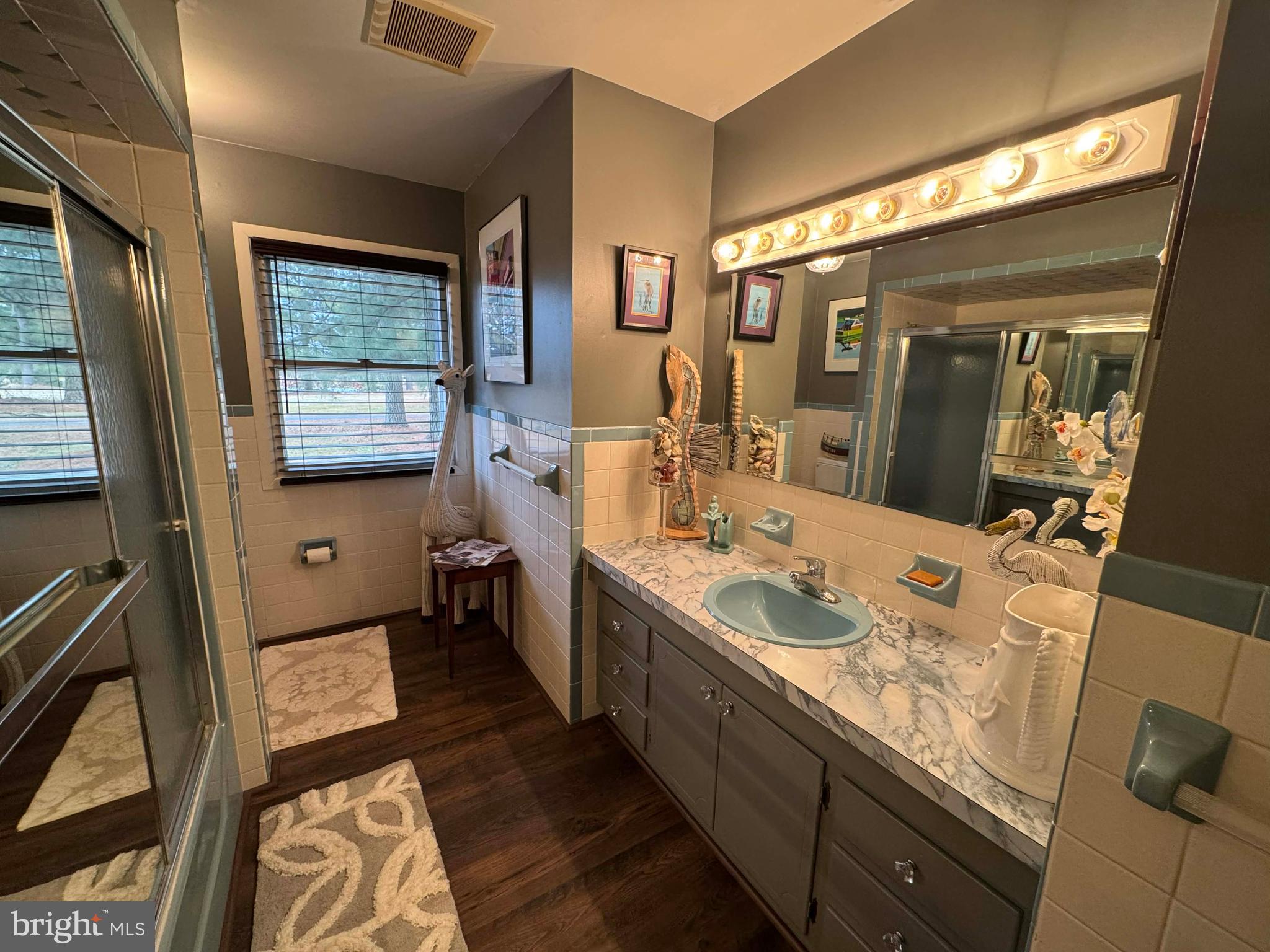 5000 Joshua Thomas Road Marion Station, MD 21838 - Photo 79 of 81 a bathroom with a double vanity sink toilet mirror and window