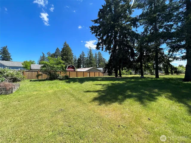 a view of a park with swings and a trees