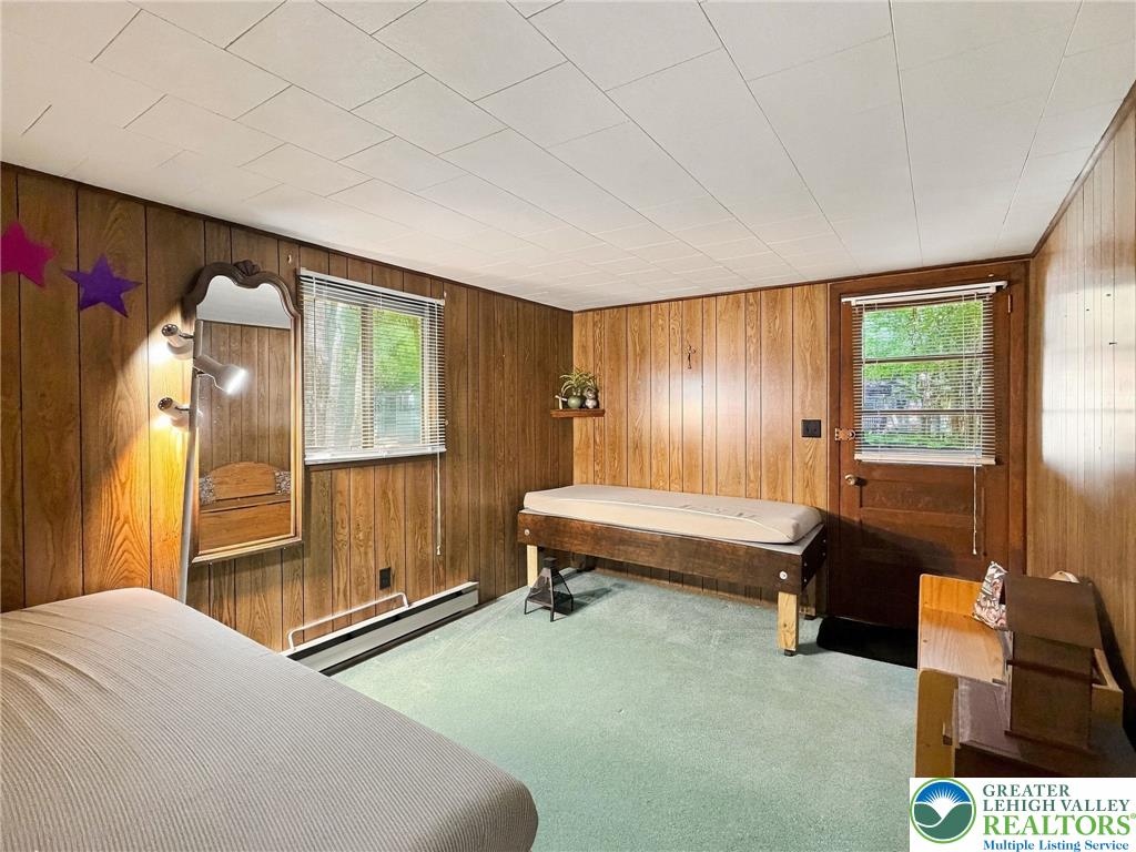 116 Aspen Road Albrightsville, PA 18210 - Photo 30 of 33 Classic wood paneling wraps this cozy room featuring direct outdoor access and carpeted flooring.