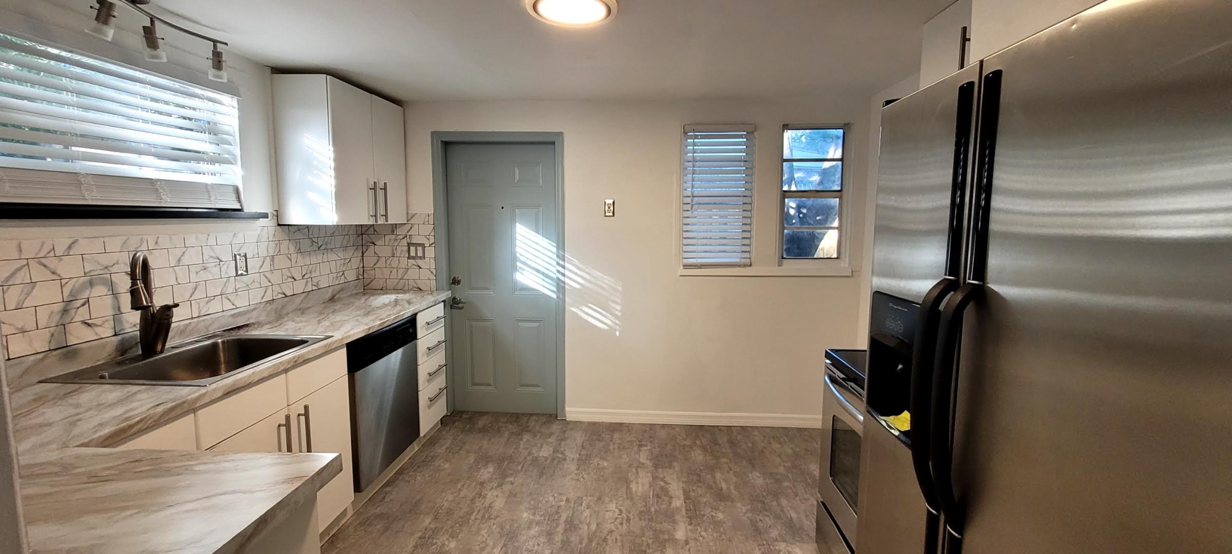 104 Northeast 5th Street Fort Lauderdale, FL 33301 - Photo 13 of 26 a kitchen with a sink a refrigerator and window