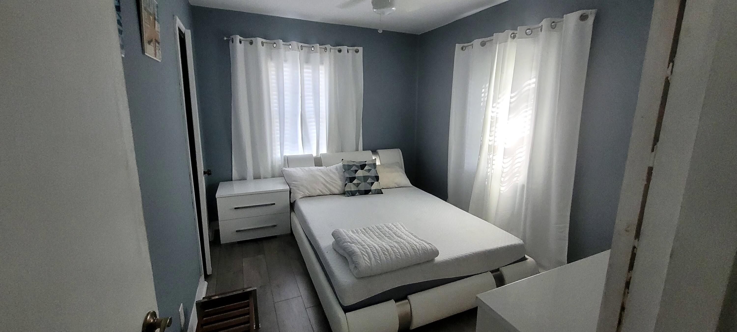 104 Northeast 5th Street Fort Lauderdale, FL 33301 - Photo 18 of 26 a bedroom with a bed and a window