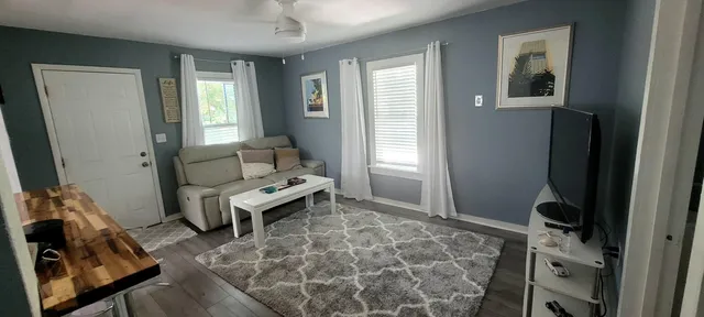 a kitchen with stainless steel appliances a sink cabinets and wooden floor