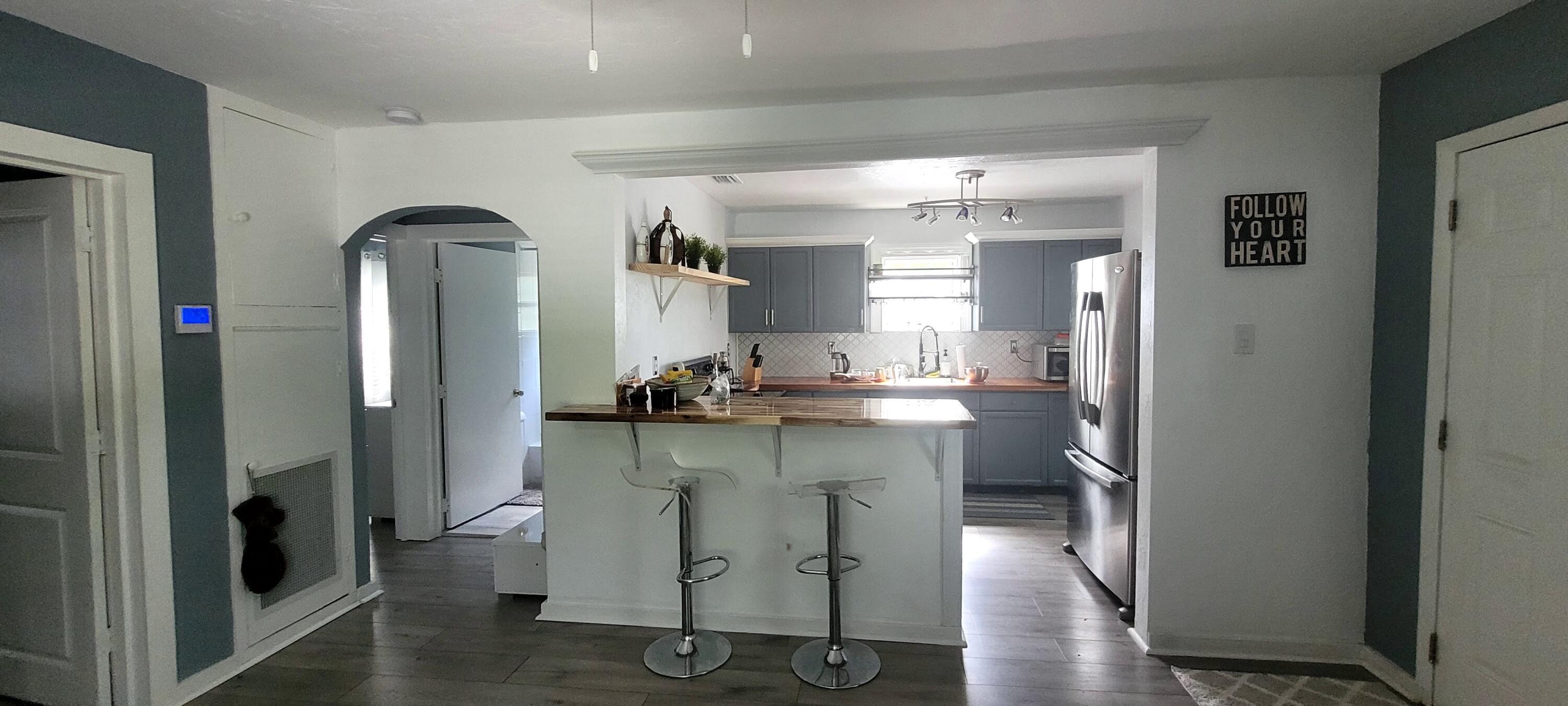 104 Northeast 5th Street Fort Lauderdale, FL 33301 - Photo 22 of 26 a kitchen with stainless steel appliances a sink cabinets and wooden floor