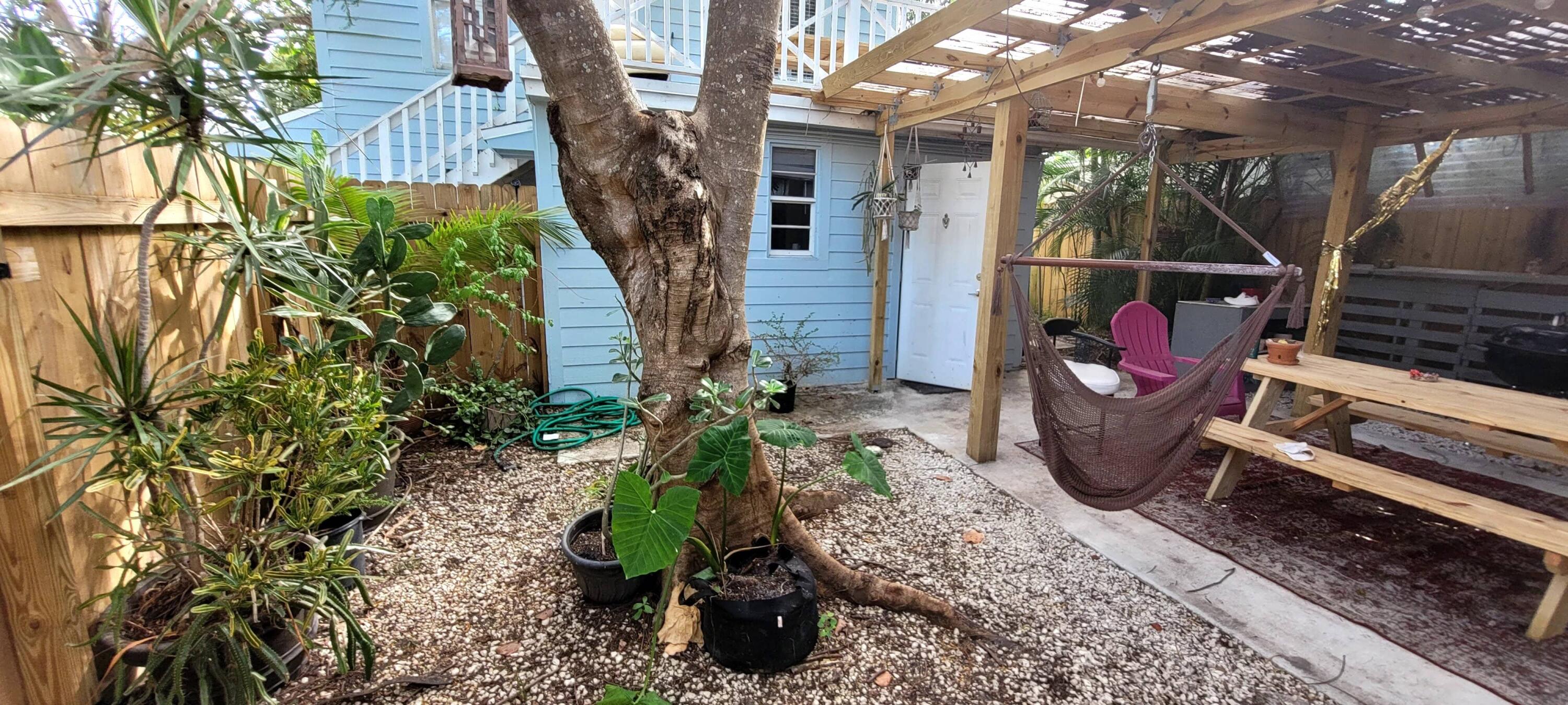 104 Northeast 5th Street Fort Lauderdale, FL 33301 - Photo 4 of 26 a backyard of a house with barbeque oven table and chairs
