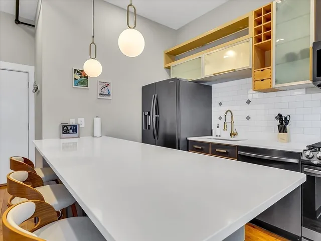 a kitchen with stainless steel appliances a refrigerator and a stove