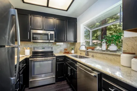 a kitchen with a sink stove and microwave