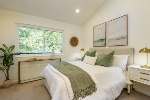 a bedroom with a bed and window