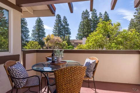 a view of a chairs and table in the balcony