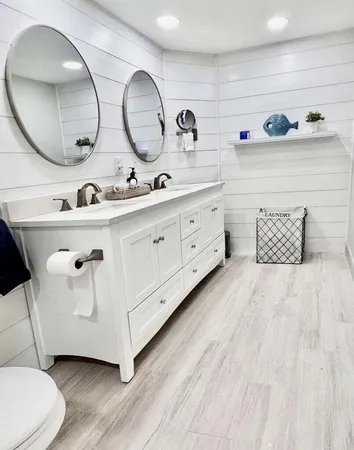 a spacious bathroom with a double vanity sink and a mirror